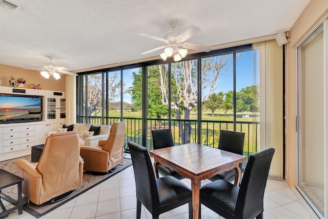 sunroom with plenty of natural light and ceiling fan