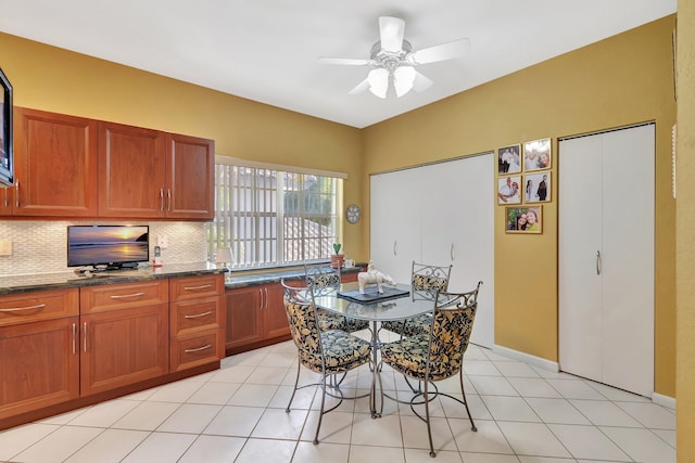 dining room featuring light tile patterned floors and ceiling fan