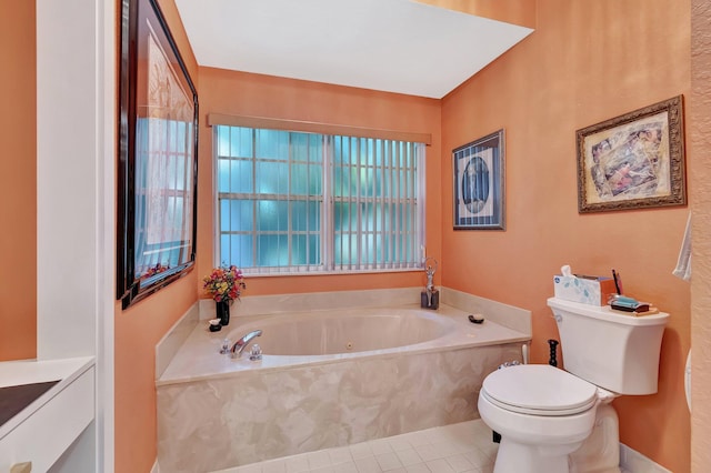 bathroom featuring a washtub, vanity, tile patterned floors, and toilet