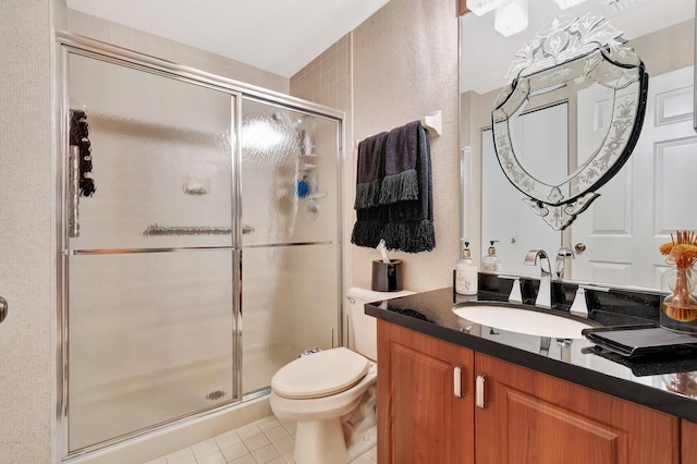 bathroom featuring tile patterned flooring, vanity, toilet, and a shower with shower door