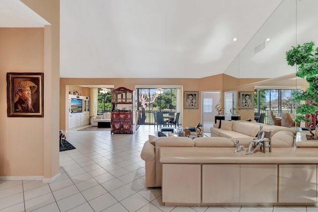 tiled living room with a healthy amount of sunlight and high vaulted ceiling