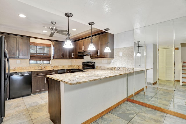 kitchen featuring kitchen peninsula, light stone countertops, black appliances, dark brown cabinetry, and decorative light fixtures