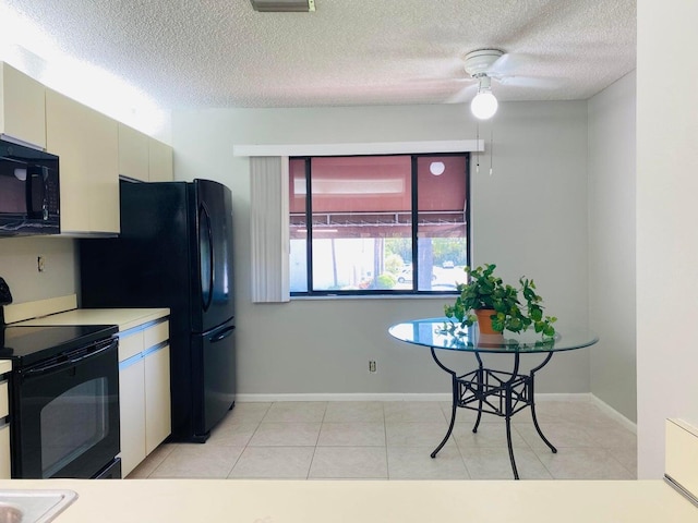 kitchen featuring black appliances, baseboards, light countertops, light tile patterned floors, and a textured ceiling