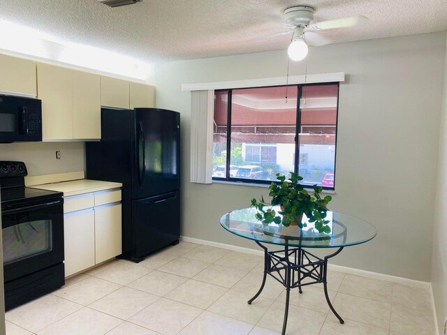 kitchen with black appliances, light tile patterned flooring, and ceiling fan