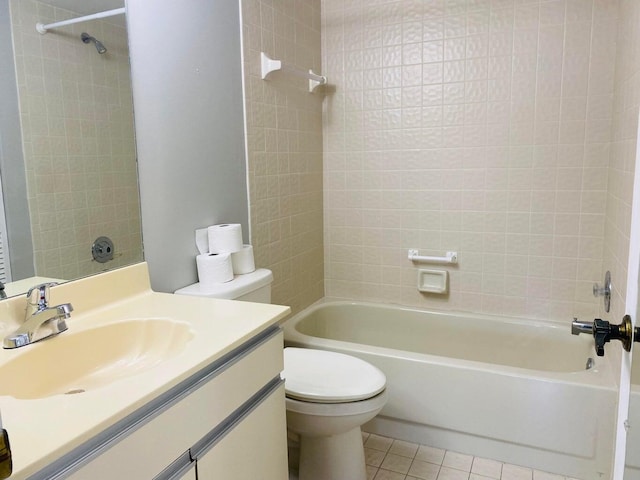 full bathroom with tile patterned floors, tiled shower / bath combo, vanity, and toilet