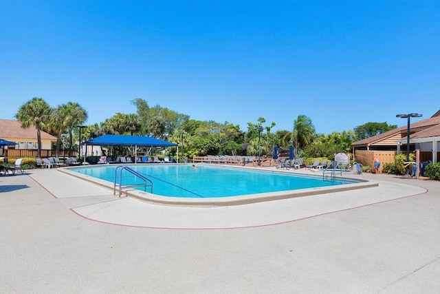 pool featuring a patio area and fence