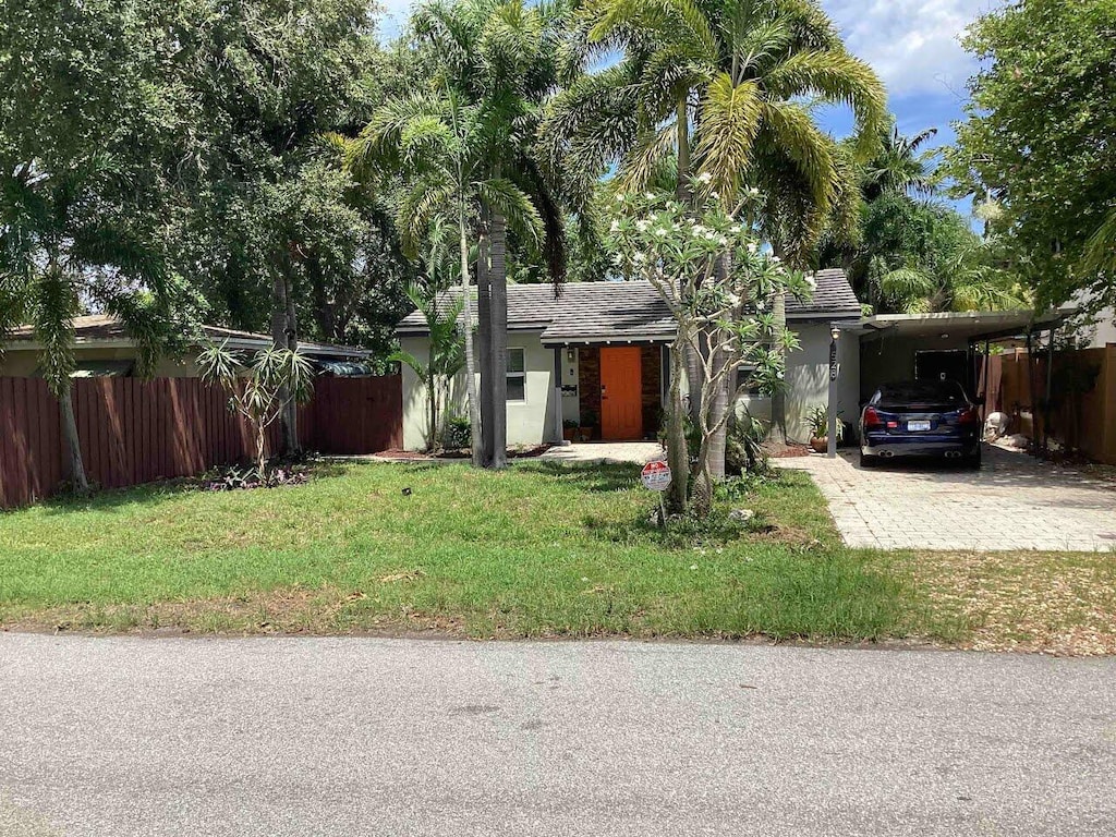 view of front of house with a carport and a front yard