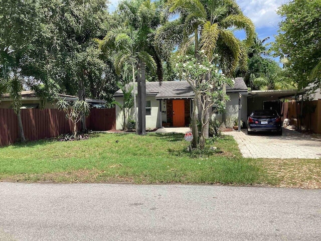 1528 NE 1st Ave, Fort Lauderdale, FL 33304 - ranch-style home featuring stucco siding, a front lawn, fence, and driveway