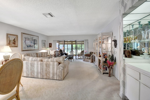 carpeted living room featuring a textured ceiling