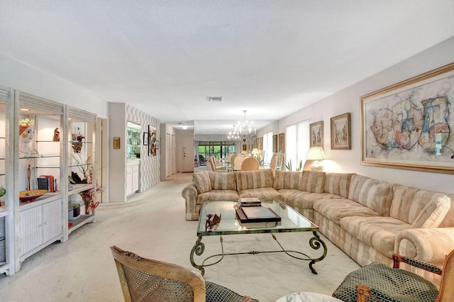 carpeted living room with a textured ceiling and an inviting chandelier