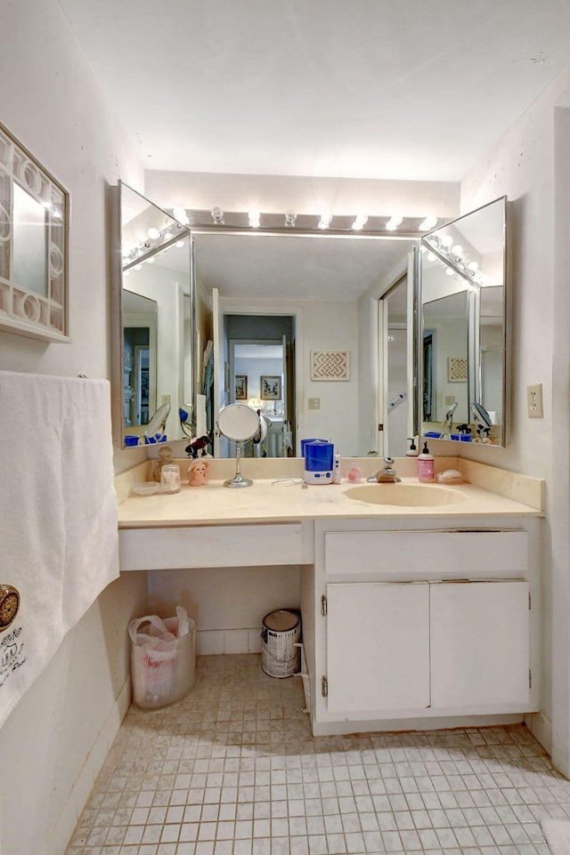 bathroom with double vanity and tile patterned floors