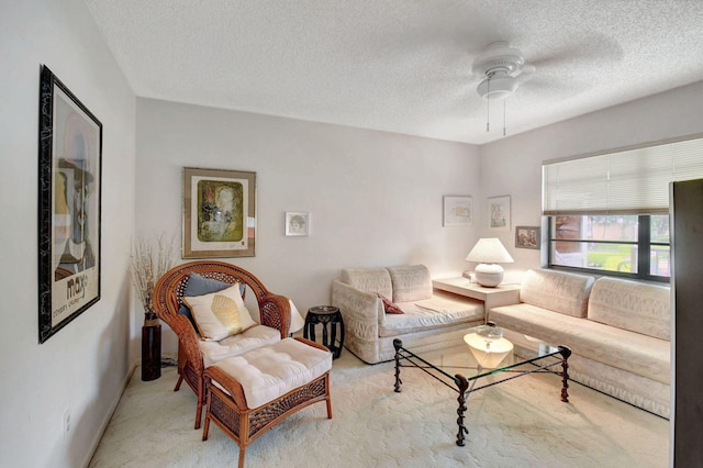 living room with light carpet, a textured ceiling, and ceiling fan