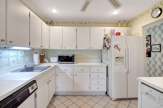 kitchen with tasteful backsplash, white appliances, sink, light tile patterned floors, and white cabinetry