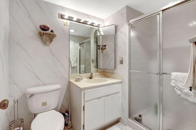 bathroom featuring vanity, toilet, and an enclosed shower