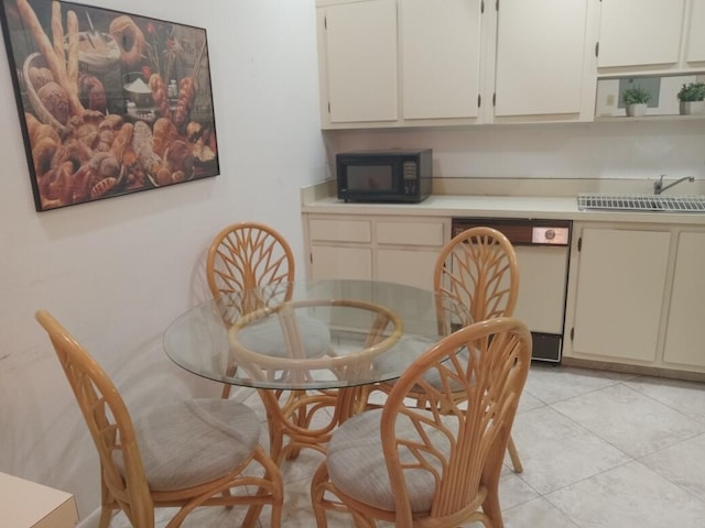 tiled dining space featuring sink