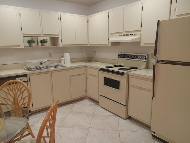 kitchen featuring white appliances, sink, and light tile patterned floors