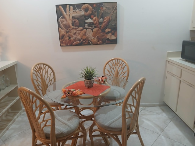 tiled dining room featuring ceiling fan with notable chandelier