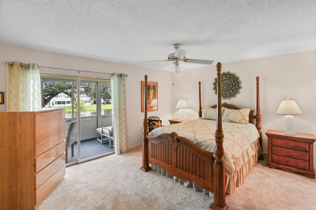 carpeted bedroom with a textured ceiling and ceiling fan