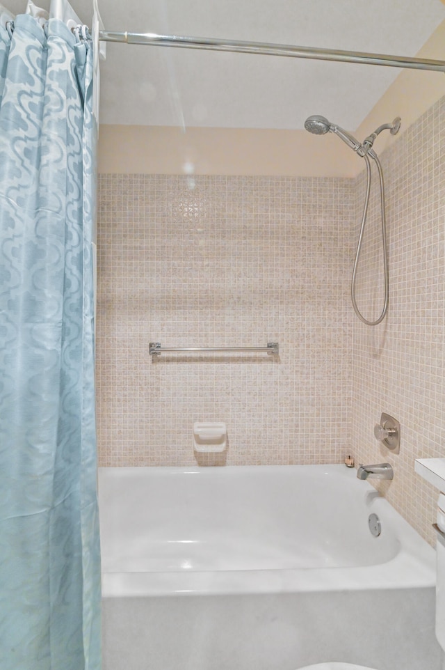 bathroom featuring shower / bathtub combination with curtain