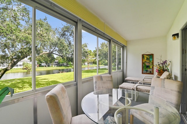 sunroom / solarium featuring a water view