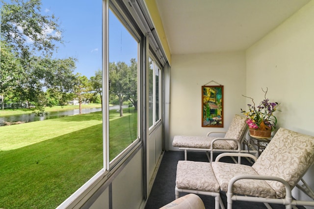 sunroom / solarium featuring a water view