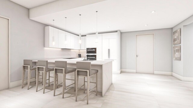 kitchen featuring a peninsula, white cabinetry, light countertops, and a kitchen breakfast bar