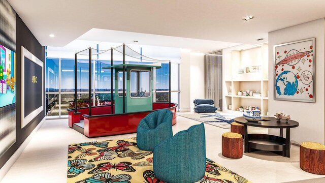 living area featuring floor to ceiling windows and recessed lighting