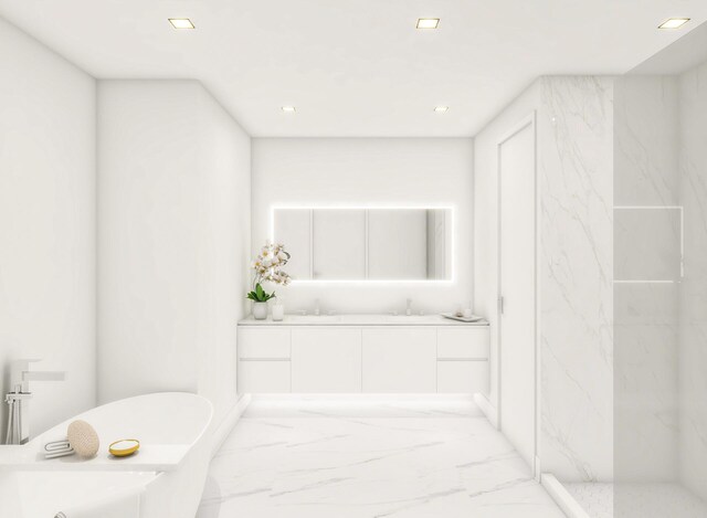 full bathroom featuring marble finish floor, a sink, recessed lighting, double vanity, and a freestanding bath