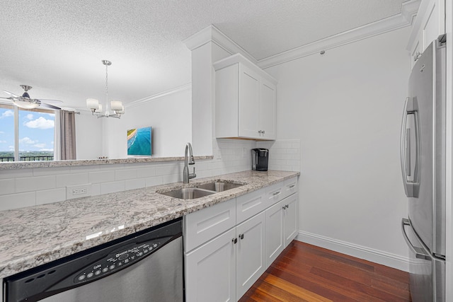 kitchen featuring a sink, appliances with stainless steel finishes, backsplash, dark wood-style floors, and crown molding