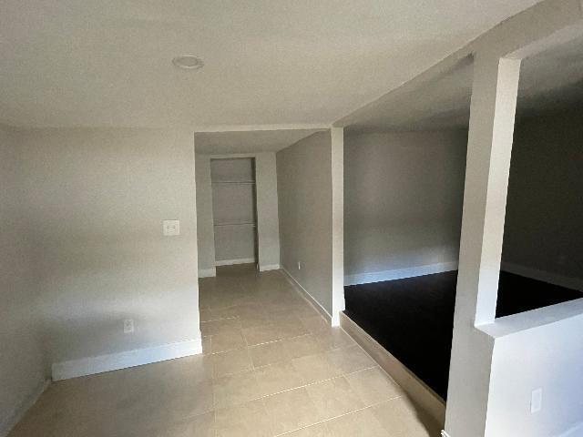 hall with light tile patterned flooring