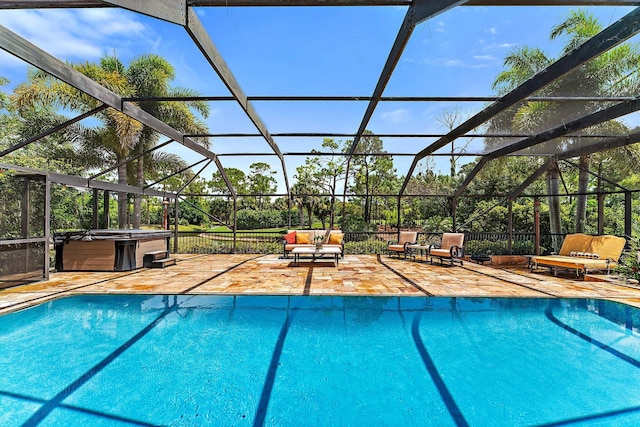 pool featuring a patio, a hot tub, fence, a lanai, and an outdoor living space