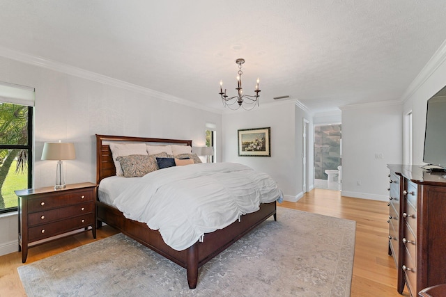 bedroom with connected bathroom, light wood-type flooring, crown molding, and a notable chandelier