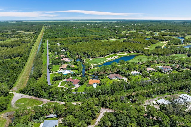 birds eye view of property with a water view and a wooded view
