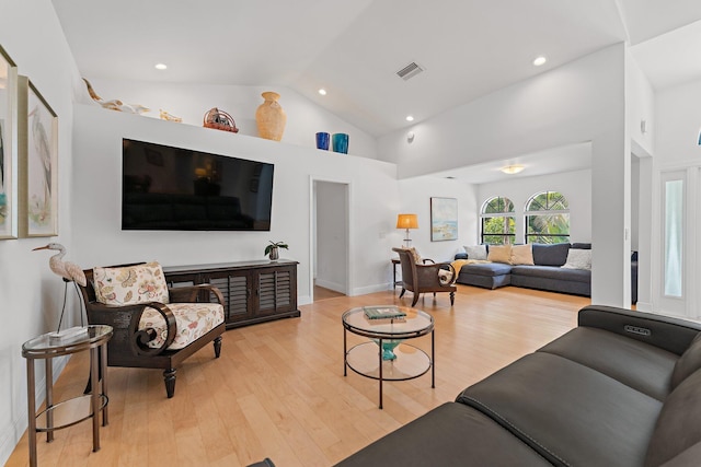 living room with light wood finished floors, recessed lighting, visible vents, high vaulted ceiling, and baseboards