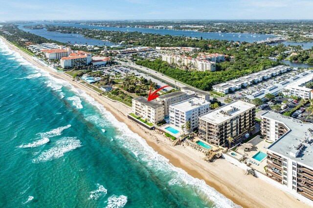 bird's eye view featuring a view of the beach and a water view