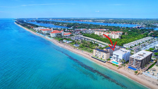 birds eye view of property with a view of the beach and a water view