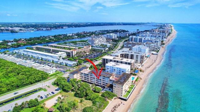 bird's eye view featuring a water view and a beach view