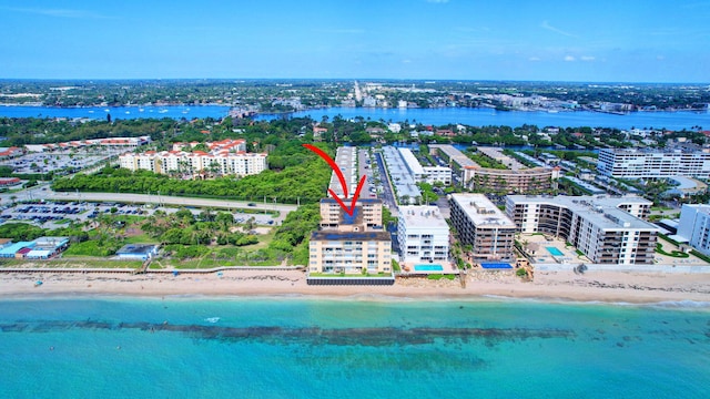 bird's eye view featuring a water view and a beach view