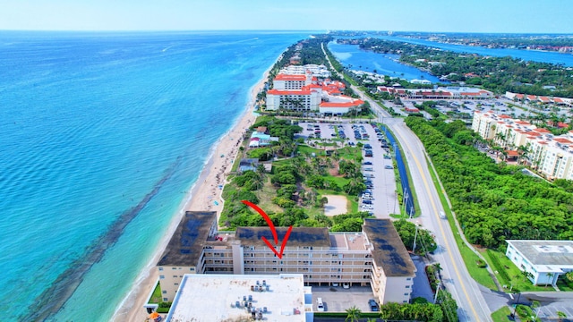 aerial view with a water view and a view of the beach