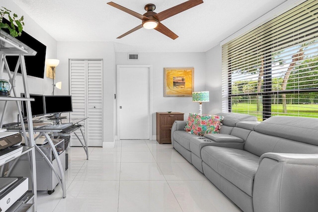 living room featuring light tile patterned floors and ceiling fan