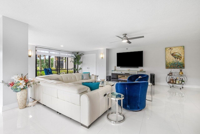 tiled living room with ceiling fan and a textured ceiling