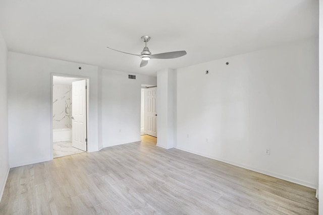 empty room with ceiling fan and light hardwood / wood-style flooring