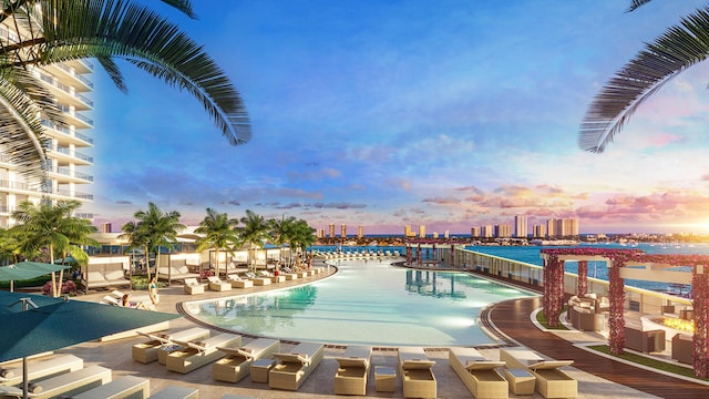 pool at dusk featuring a patio area