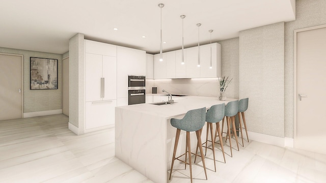 kitchen with a kitchen bar, sink, white cabinetry, kitchen peninsula, and pendant lighting