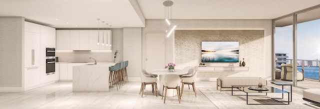 kitchen featuring hanging light fixtures, kitchen peninsula, expansive windows, oven, and white cabinets