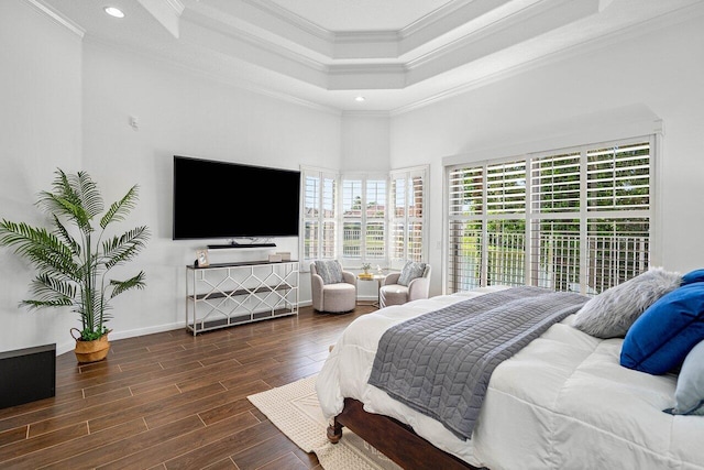 bedroom featuring dark hardwood / wood-style flooring, a raised ceiling, and crown molding