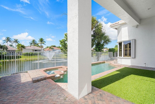 view of swimming pool with a patio, a lawn, an in ground hot tub, and a water view