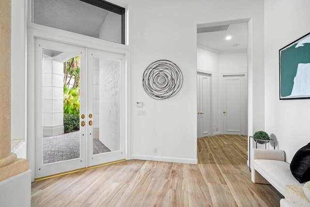 entryway featuring light wood-type flooring and french doors