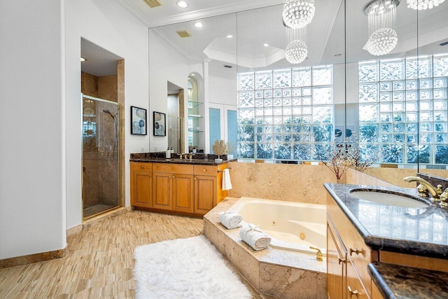 bathroom with vanity, shower with separate bathtub, hardwood / wood-style floors, and crown molding