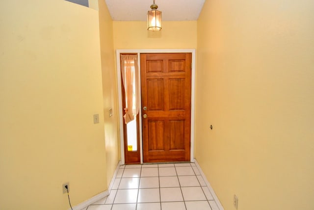 doorway to outside with light tile patterned floors